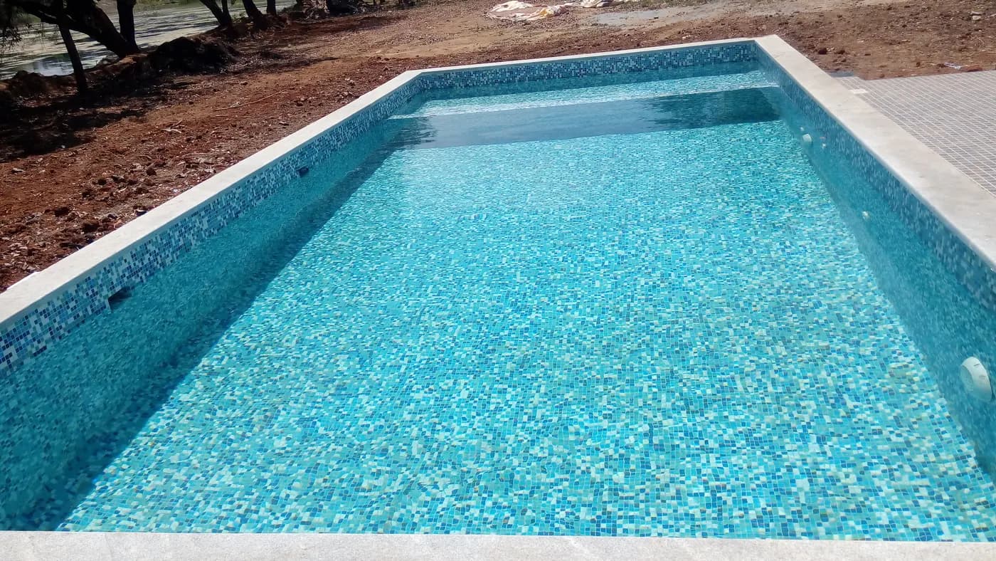 Mosaic-tiled farm pool, freshly filled