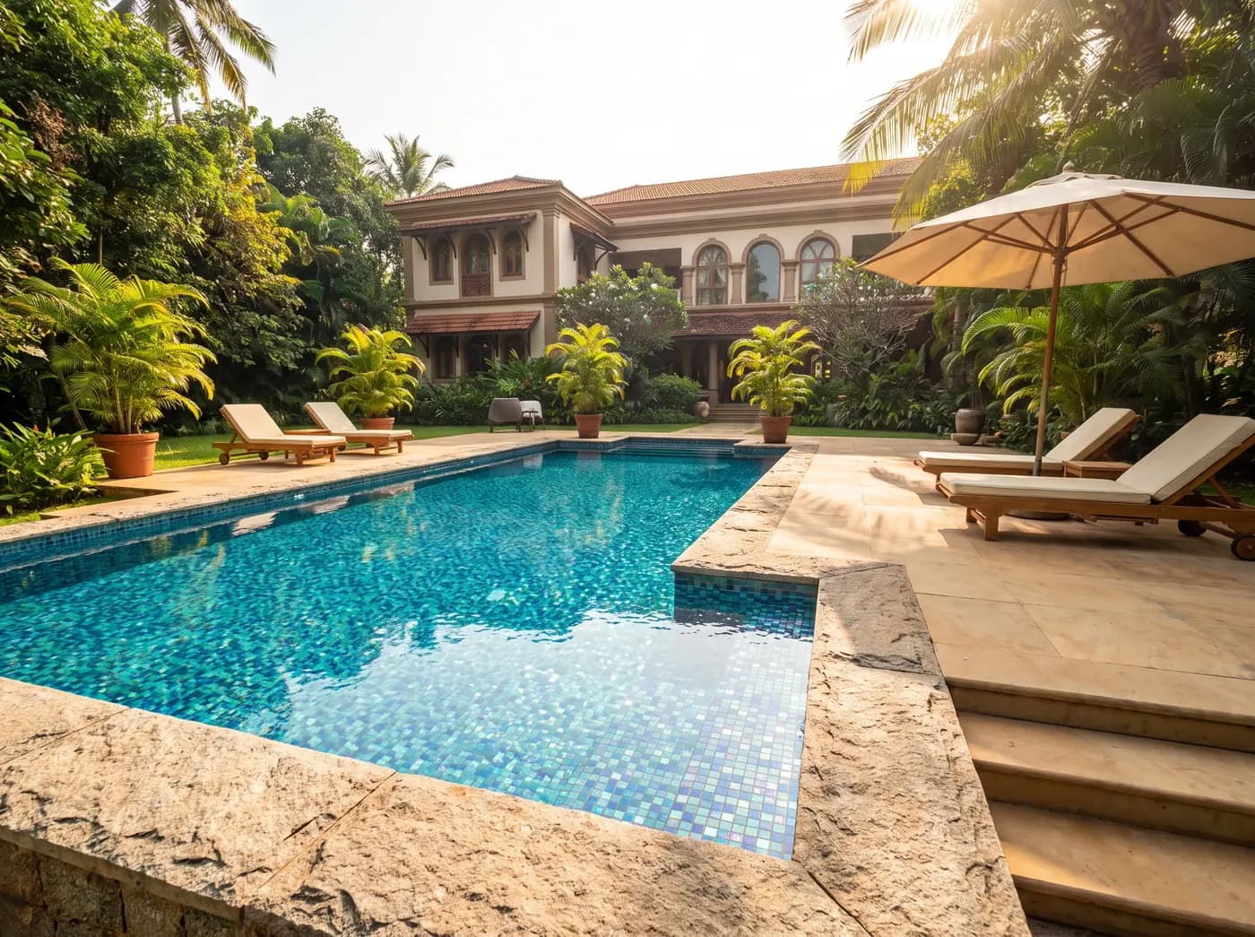 A mosaic-finished garden pool surrounded by planting.