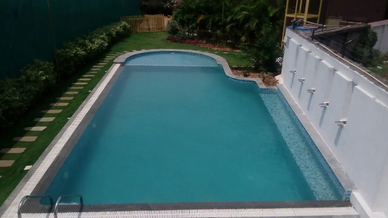 Landscaped pool with spout wall